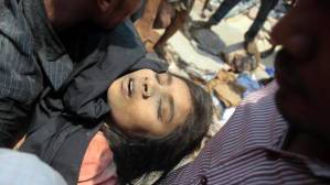 A dead woman pulled from the Bangladesh sweatshop in honour of cheap goods back here. Thank you Loblaws, etc.