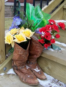 Flowers left in cowboy boots - footwear that was a piece of the man's character, left on the front porch of Peter Kormos's home, where he was found dead March 30. Photo by Doug Draper