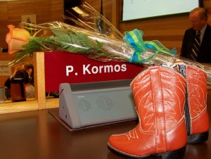 A simple orange rose - the colour of the NDP - and cowboy boots, Peter Kormos's trademark shoe ware, graces his seat in Niagara, Ontario's regional council chambers for the last time before verbal tributes and a moment of silence for him. Photo by Doug Draper