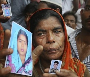 A woman weeps for lost loved ones outside the collapsed garment -making sweatshop in Bangladesh.