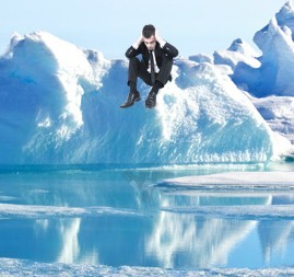 A corporate suit sits while our earth's ice caps melt.