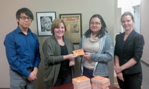 Niagara students David Nguyen, left, and Sarah Lukaszczyk and Karen Babcock, to the right, present MPP Cindy Forster this past spring with more than 2,500 post cards, signed by young people in support of a tanning bed ban in Ontario.