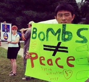 Niagara, Ontario residents express their views on a military assault on Syria in front of Niagara Falls MP and Canadian Defense Minister Rob Nicholson's constituency office.