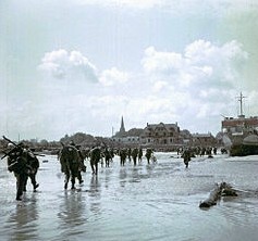 Canadian soldiers move up a Juno Beach heavily defended by Nazi trooops in Normandy, France on June 6th, 1944.