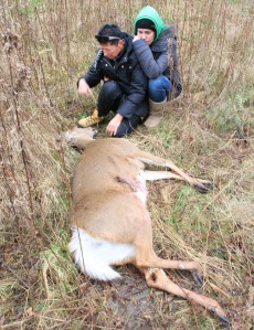 Robin Zavitz and one of her children kneel near a deer that fell dead on her Pelham property this past 2013 during an Ontario approved deer hunt in Short Hills Provincial Park. File photo by Dan Wilson