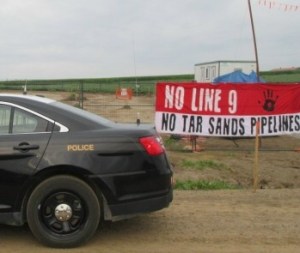 Protesters hang a banner at an Enbridge Line 9 tar sands pipe site in Ontario last year.