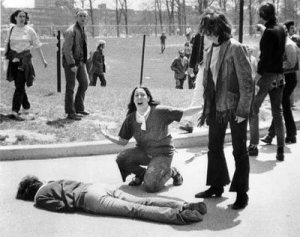 A distraught demonstratoor over the body of one of the felled students.