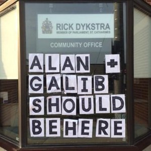 This sign, bearing the name of Alan Galib, the young Syrian boy in that heart-wrenching set of photos taken on the Turkish beach, mysteriously showed up on the front of St. Cathrines MP Rick Dystra's campaign office in recent days and is making the rounds in social media.