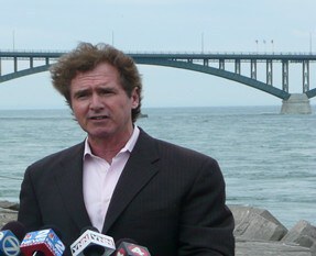 With Peace Bridge in background, U.S. Congressman Brian Higgins discusses Canana/U.S. border crossing challenges at a 2014 media conference