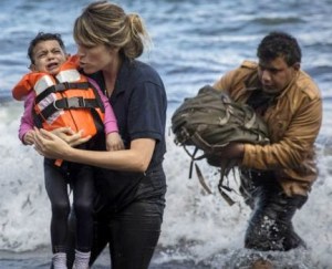Refugees make it to Greek shores after surviving a dinghy ride across the sea from their native Syria