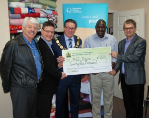 From left to right at funding presentation, St. Catharines Regional Councillor Bruce Timms, Mayor of Pelham Dave Augustyn, Niagara Regional Chair Alan Caslin, Mennonite Central Committee Refugee Program Coordinator Moses Moini, Mennonite Central Committee Executive Director Rick Cober Bauman