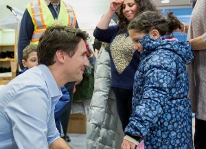 Canada's Prime Minister Justin Trudeau greets Syrian refugees arriving late this December 10th at Pearson International Airport in Toronto