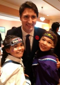Two Inuit girls pose with Prime Minister Justin Trudeau after performing throat singing at his swearing -in ceremonies in Ottawa last November