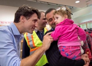 Trudeau greeting first new wave of Syrian refugees arriving in Toronto last December