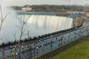 Wings for Life runners racing under the mist of the Horseshoe Falls. File photo from 2015 run