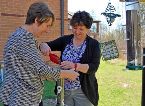 Brock University researchers Kerrie Pickering, left, and Marcie Jacklin fill a bird feeder at the Woodlands of Sunset long-term care facility in Welland. Photo courtesy of Brock University