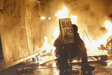 Flames light up the night in Charlotte, North Carolina following another fatal shooting of a black man in the streets.