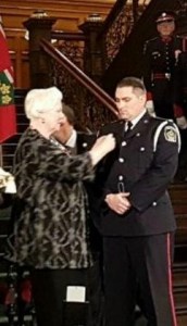 Niagara Regional Police Constable Chris Lindey at Queen's Park, receiving Medal of Bravery from Ontario's Lieutenant Government Elizabeth Dowdeswell