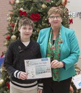 Thomas Woodruff (left) with Niagara Health President Suzanne Johnston presenting the Holiday Card Contest grand prize certificate at the St. Catharines Site. Photo courtesy of Niagara Health System